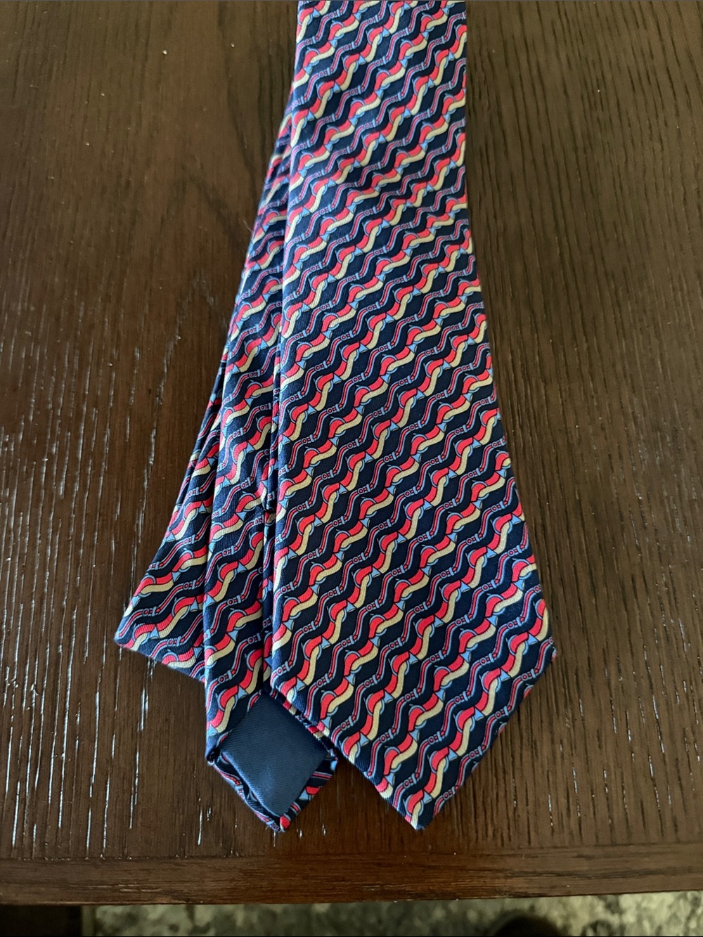 Hermes Navy Silk Tie with Red, Pink and Cream Wave Motif